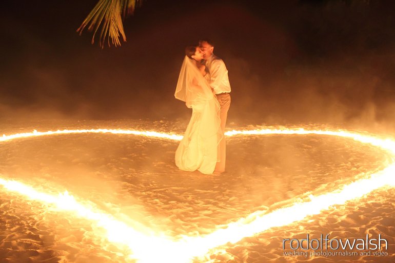 Roatan wedding photographers - bride and groom in heart of fire on sand
