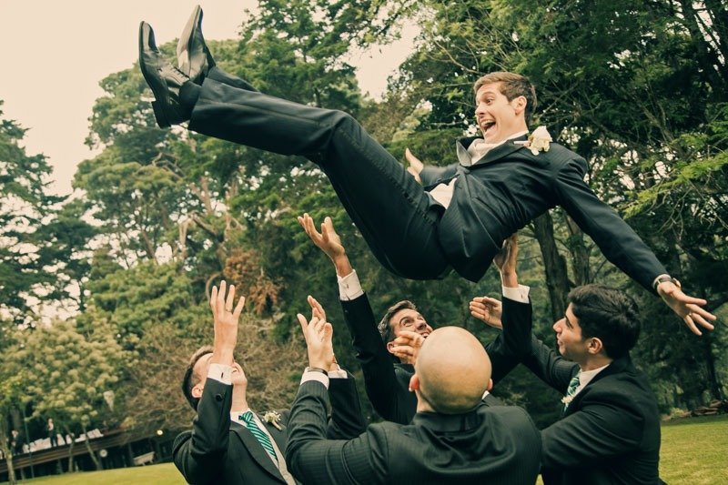 100 (17) Groomsmen tossing groom in the air in a tropical garden in San Bernardo - Wedding photographers in Guatemala